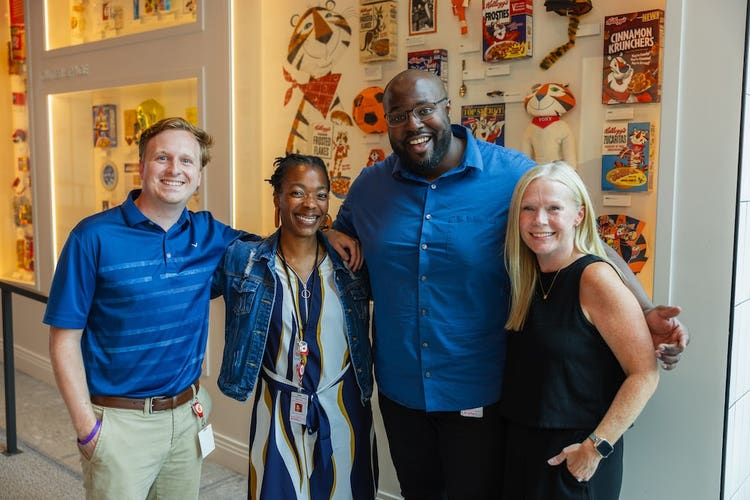 Four employees posing for a picture