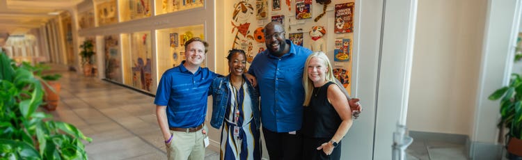 Four employees posing for a picture